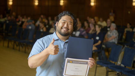 Josh Lee poses and gives a thumbs up.