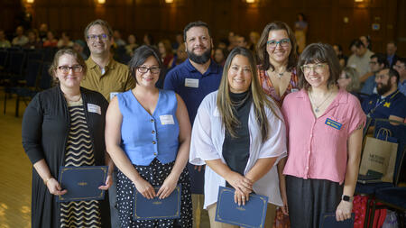 The HR team poses holding their awards.