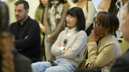 An audience of people listening intently