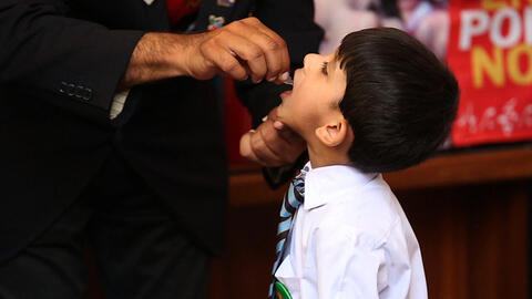 Child receiving polio vaccine in Pakistan