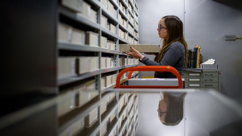 Allison Thorsen shelving a box in an archive