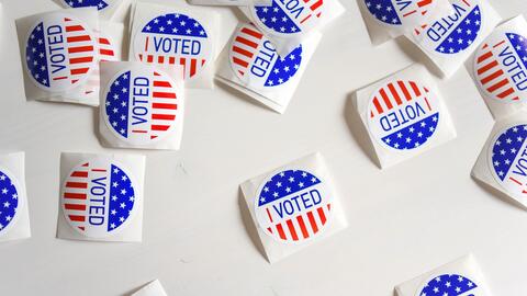 Several "I Voted" stickers spread out on a table