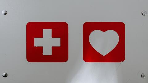 A first-aid symbol and heart symbol