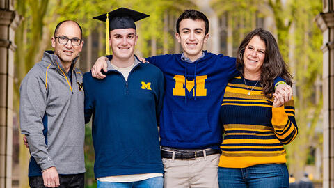 The Ehrenberg family smiling and dressed in U-M colors. 
