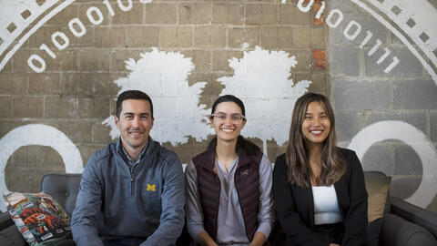 Mike, Sierre and Alice sit on a couch at the Duo headquarters in Ann Arbor