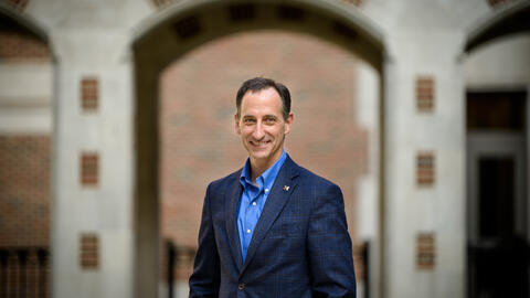 A headshot of Paul Resnick standing in the North Quad courtyard