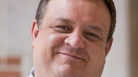 Dragomir Radev pictured with a tilted head and a warm, close-mouthed smile