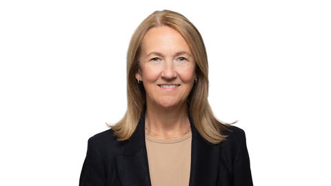 A professional headshot of Stephanie Teasley wearing a black blazer and smiling at the camera. She has blonde hair. 
