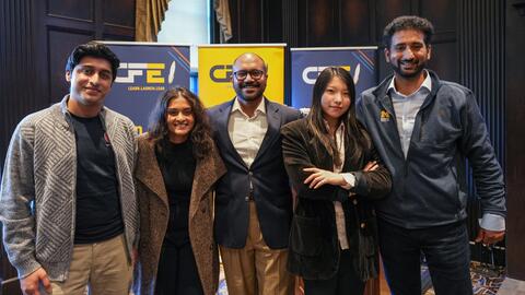 Team members Hamza Naveed, Tanwee Deshpande, Dushyanth Aluwihare, Cindy Ye and Mohan Koushik Tupakula pose for a group photo in front of banners with the Center for Entrepreneurship logo