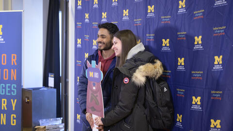 Students pose with a Mumsi cutout at the 2023 Giving Blueday celebration