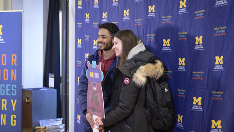 Students pose with a Mumsi cutout at the 2023 Giving Blueday celebration