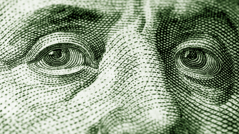 Close-up of eyes on U.S. currency.