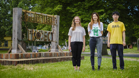 Students stand next to a heidelberg project sign