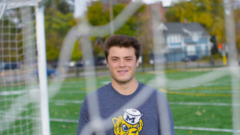 Benjamin Riela stands near a soccer net on the U-M campus.