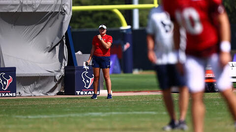 Samantha Thick observing football players on the field