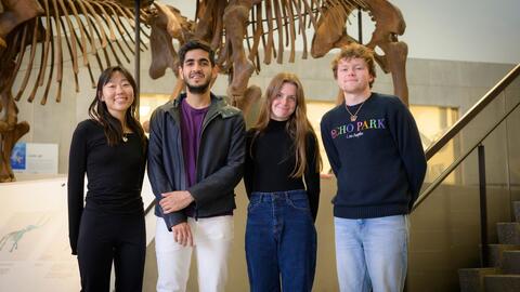 students near a fossil in a museum
