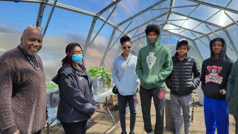 People stand inside a geometric greenhouse