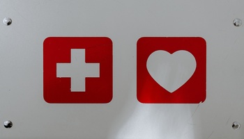 A first-aid symbol and heart symbol