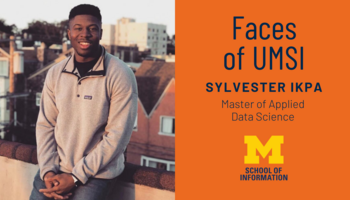 Faces of UMSI: Sylvester Ikpa. Sylvester sits on a roof. More buildings are trees are in the background behind him.