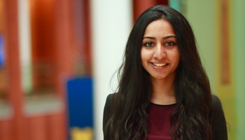 Avantika Bagri's business headshot featuring her smiling in a black suit