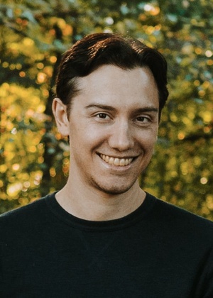 A headshot of Anthony Giove in front of trees