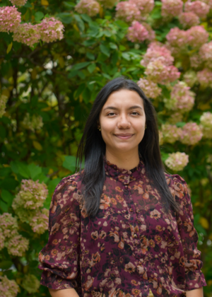 Yuliet Verbel standing in front of a flowering bush
