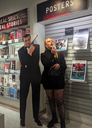 A photo of Jess Cummings posing at the International Spy Museum