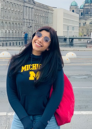 Amna Batool smiling and wearing a University of Michigan sweatshirt