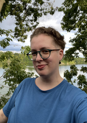 Meryl Baker standing in front of a lake and trees