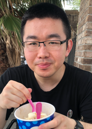Yao Lyu holding a cup of ice cream.