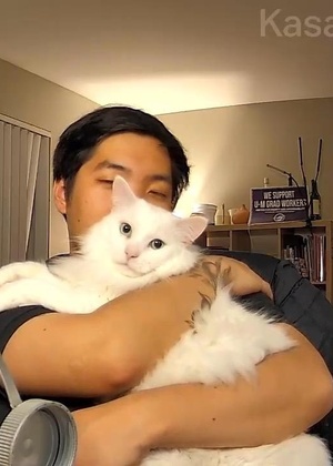 Nathan Kim holding a white long-haired cat.