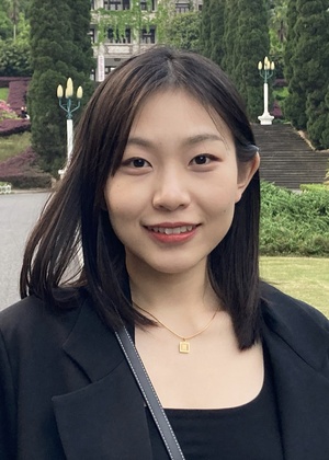 A headshot of Zixin Wang taken outside