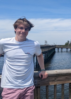 Andrew Balch standing in front of a body of water. 
