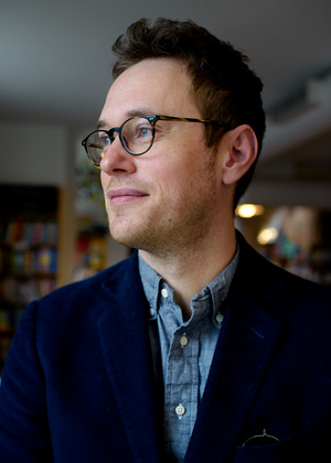 Mike Gustafson looks out at window at the Literati Bookstore