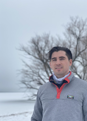 Headshot of Nick Sidor smiling in the snow