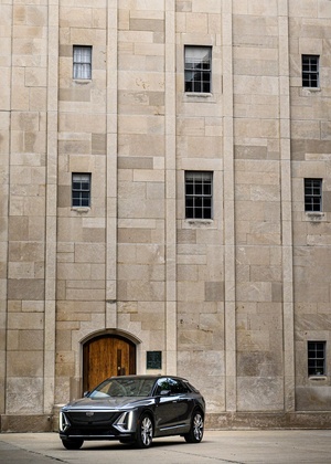An SUV parked in front of a tall bell tower
