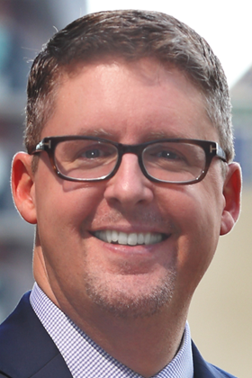 A headshot of John F. Szabo