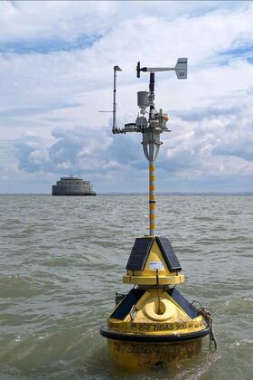A yellow buoy in lake water