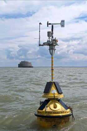 A yellow buoy in lake water