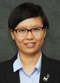Photo of Xiaofan Liang, a person with short black hair, wearing a blazer and blue shirt and glasses, smiling.  