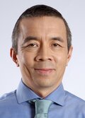 David Ong, wearing a blue shirt and teal colored tie, smiling. 