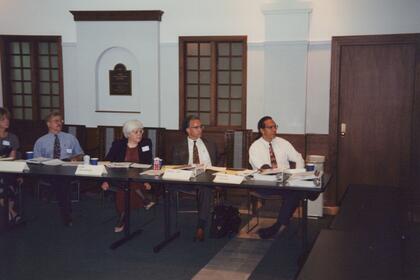Members of the Kellogg Foundation sit at a long table.
