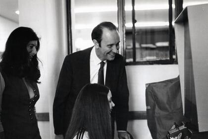 Russell E. Bidlack looks at a microfiche machine with students.