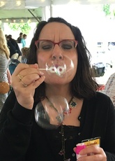 Alexis Antracoli blowing bubbles at the camera