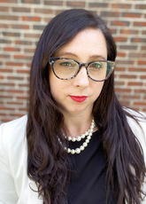 Kate Donovan stands in front of a brick wall