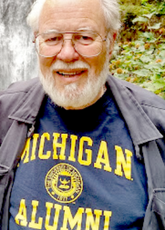 A headshot of Paul Trescott Jackson wearing a University of Michigan Alumni shirt