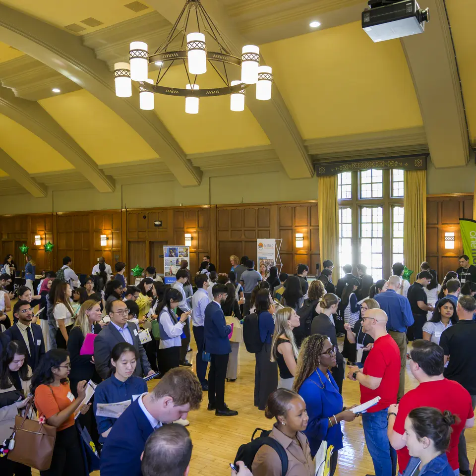 Hundreds of students talk with recruiters at a career fair.